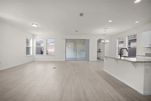 a bathroom with a granite countertop toilet a sink and a mirror