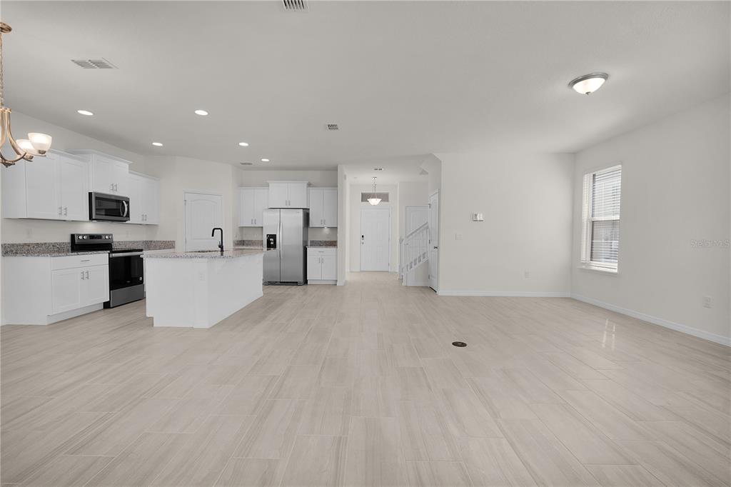 Undisclosed Address Winter Garden, FL 34787 - Photo 18 of 46 a view of a kitchen with a sink and dishwasher a refrigerator with white cabinets