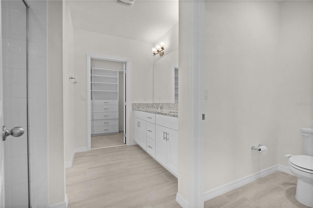 Undisclosed Address Winter Garden, FL 34787 - Photo 25 of 46 a bathroom with a granite countertop sink a toilet and shower