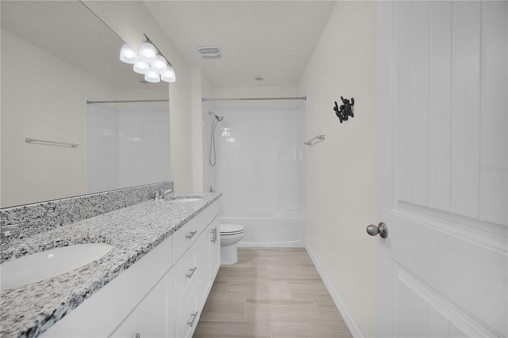 Undisclosed Address Winter Garden, FL 34787 - Photo 33 of 46 a bathroom with a granite countertop sink a toilet and shower