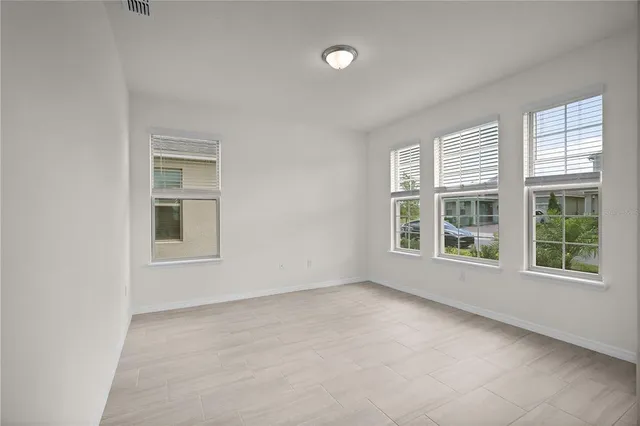 a view of a kitchen with a sink and dishwasher a refrigerator with white cabinets