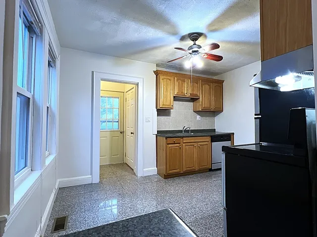 a kitchen with a refrigerator and a sink
