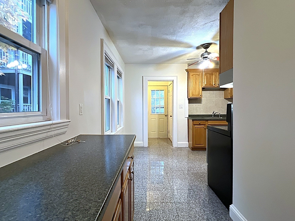 6 Oxford Avenue, Unit SIX Belmont, MA 02478 - Photo 6 of 13 a view of a kitchen cabinets and wooden floor