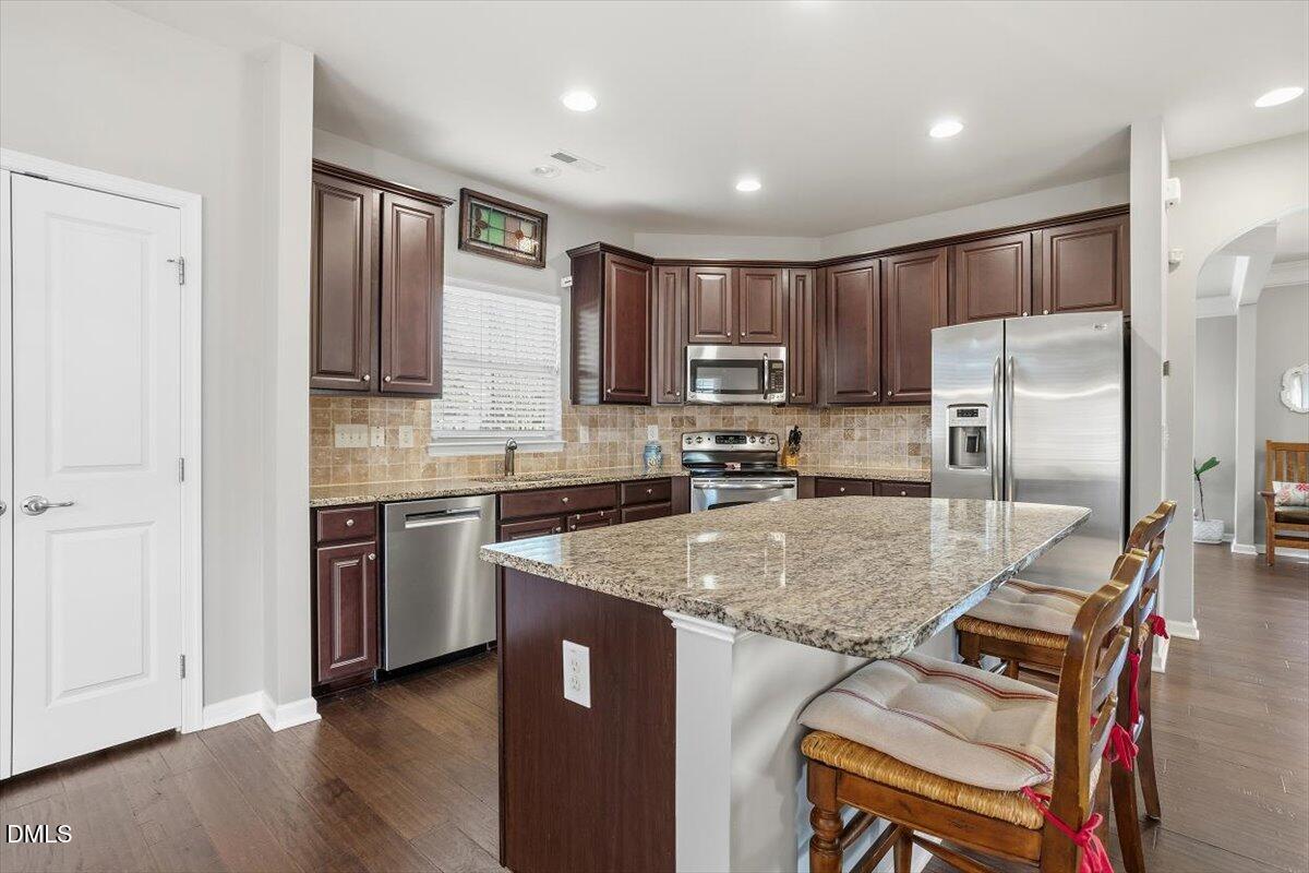 1500 Hemby Ridge Lane Morrisville, NC 27560 - Photo 10 of 50 a kitchen with stainless steel appliances granite countertop a sink refrigerator and microwave