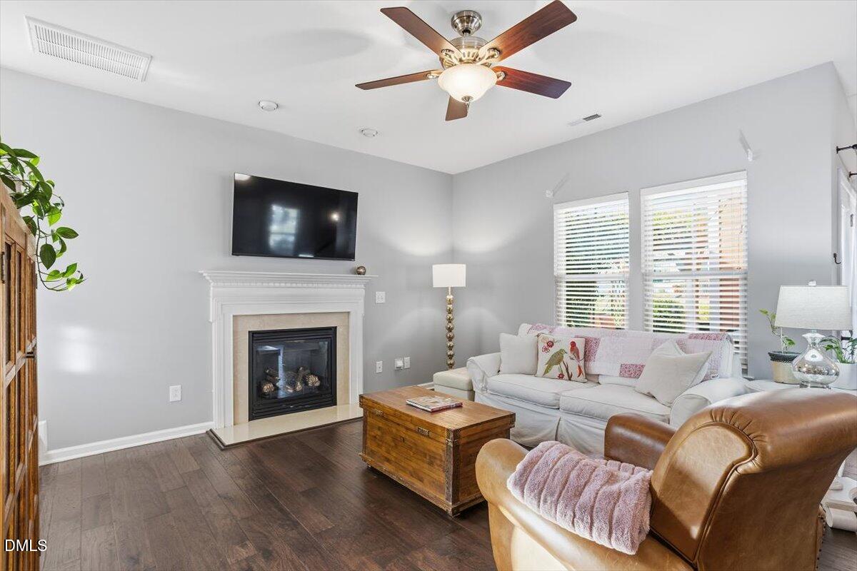 1500 Hemby Ridge Lane Morrisville, NC 27560 - Photo 14 of 50 a living room with furniture a flat screen tv and a fireplace