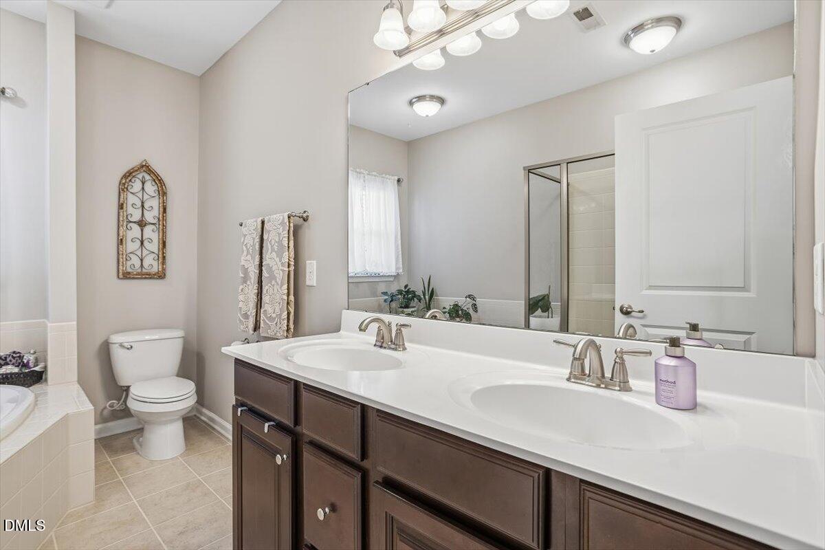1500 Hemby Ridge Lane Morrisville, NC 27560 - Photo 19 of 50 a bathroom with a sink double vanity and toilet