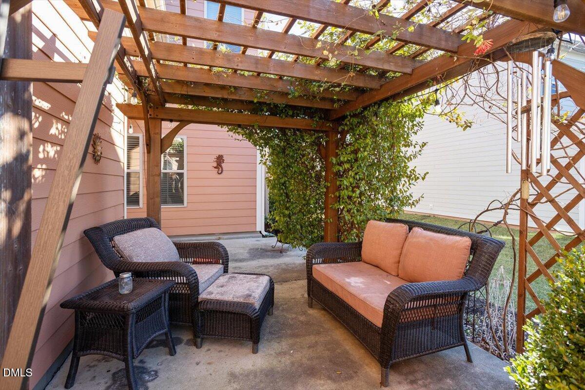 1500 Hemby Ridge Lane Morrisville, NC 27560 - Photo 29 of 50 a outdoor living space with furniture and a black umbrella
