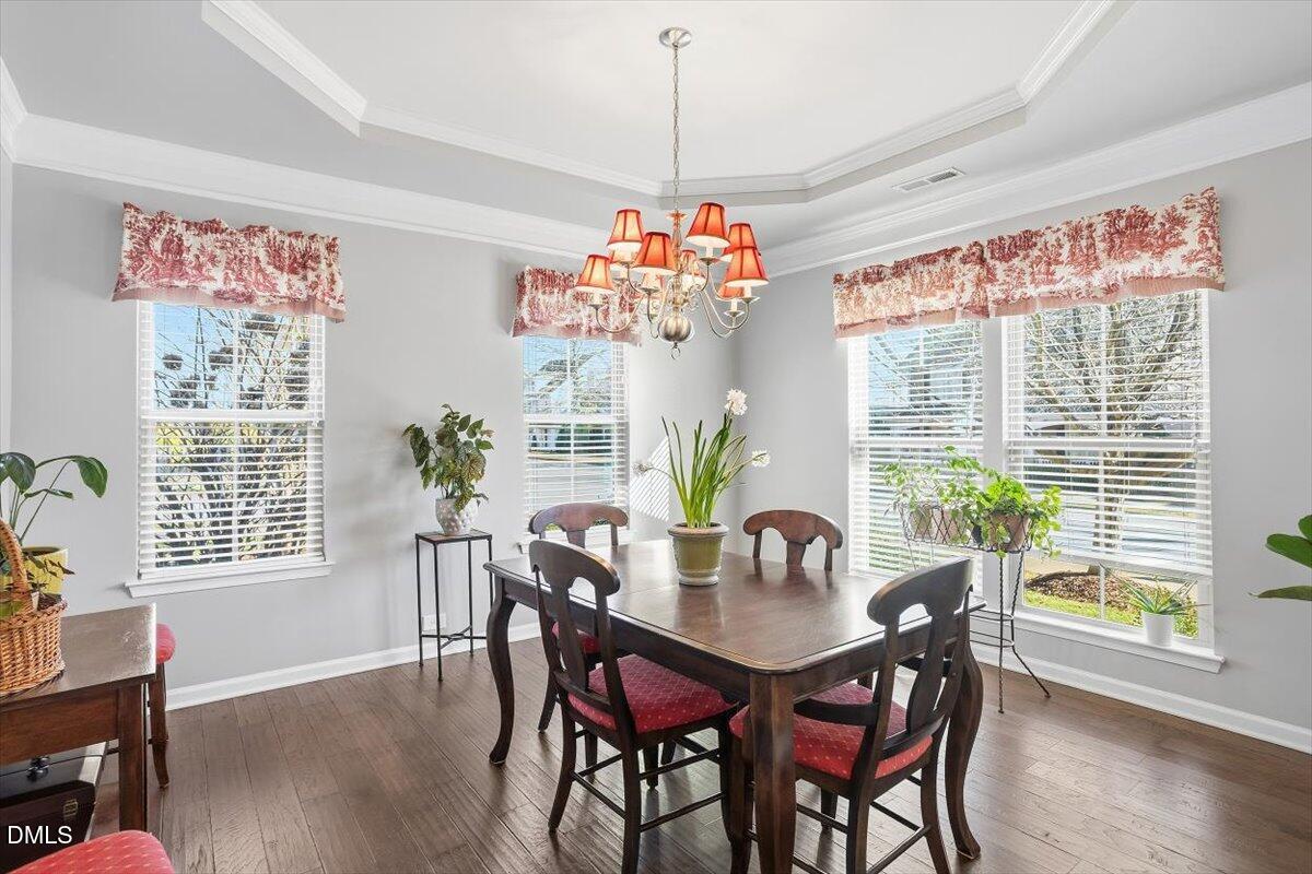 1500 Hemby Ridge Lane Morrisville, NC 27560 - Photo 6 of 50 a dining room with furniture a chandelier and wooden floor