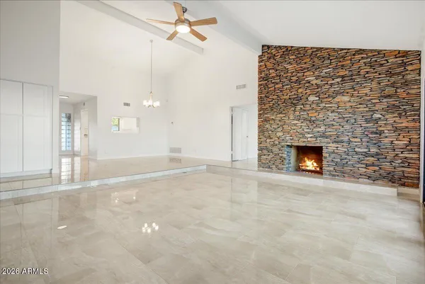 a view of empty room with a fireplace