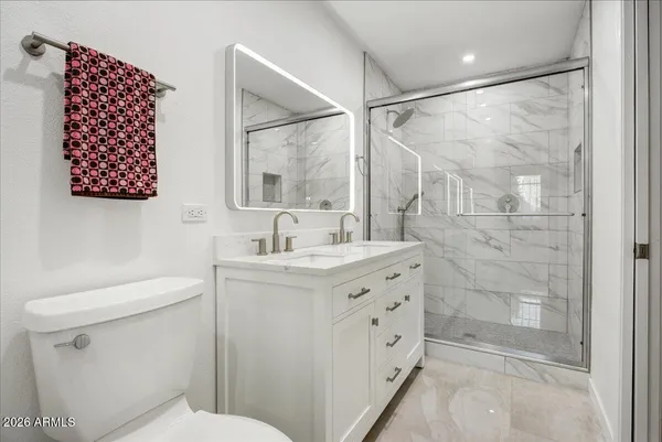 a bathroom with a sink toilet and shower