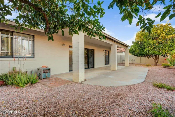 a view of a house with a tree in front of it