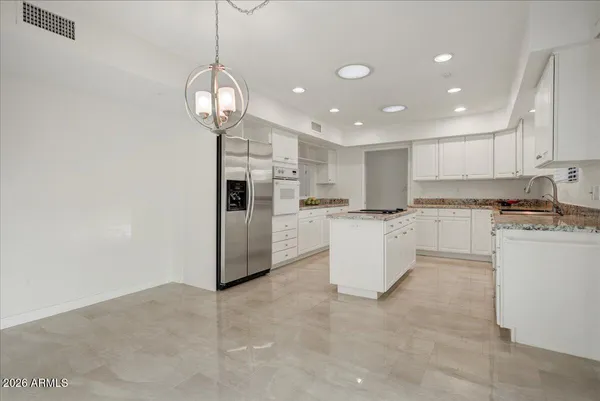 a kitchen with refrigerator and cabinets