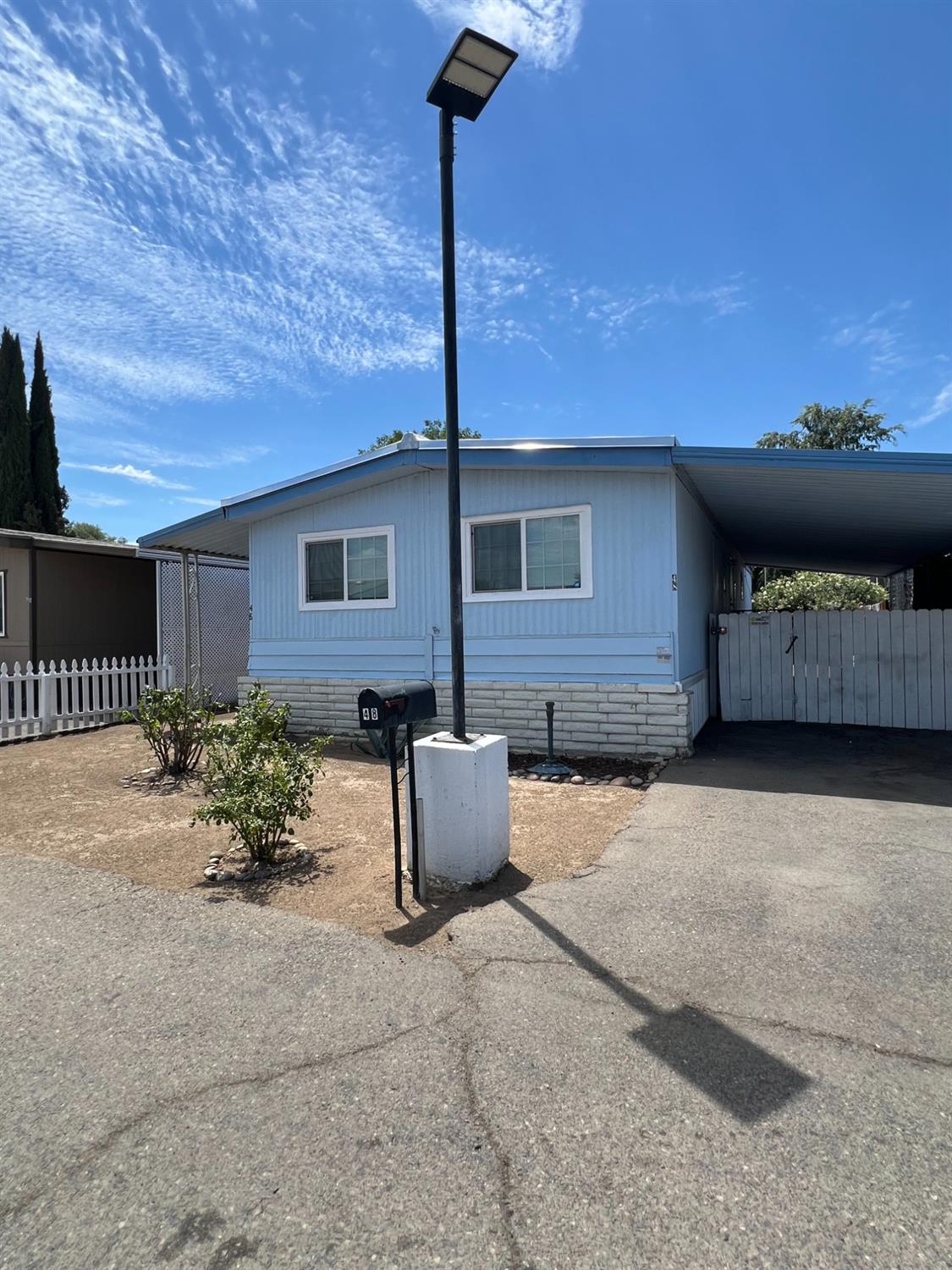 2110 Helm Avenue, Unit 48 Clovis, CA 93612 - Photo 2 of 9 a backyard of a house with table and chairs