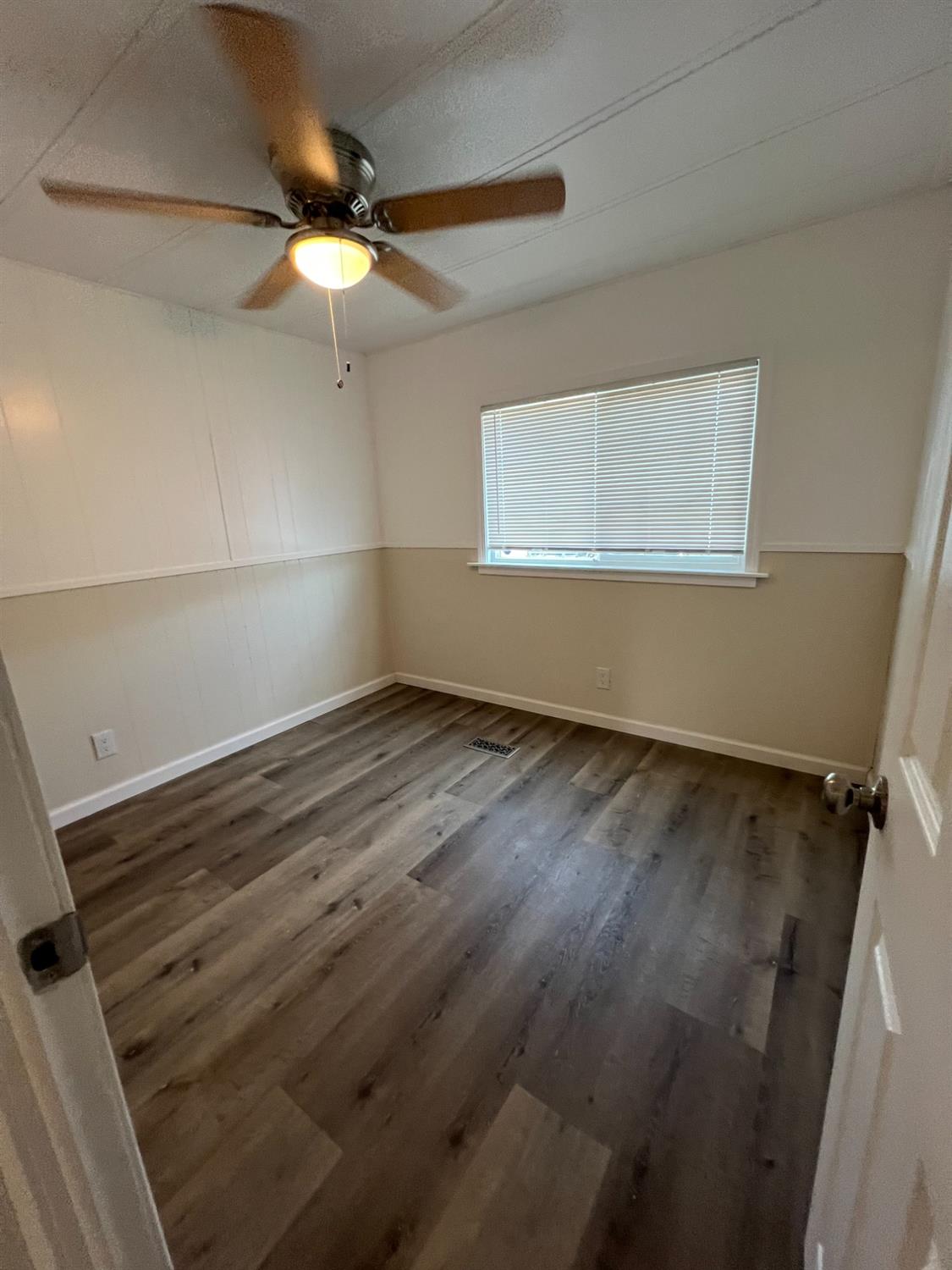 2110 Helm Avenue, Unit 48 Clovis, CA 93612 - Photo 9 of 9 a view of a room with wooden floor and fan