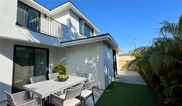 a view of backyard of house and outdoor seating
