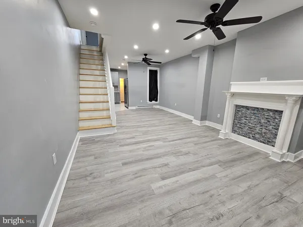 wooden floor in an empty room with a fireplace