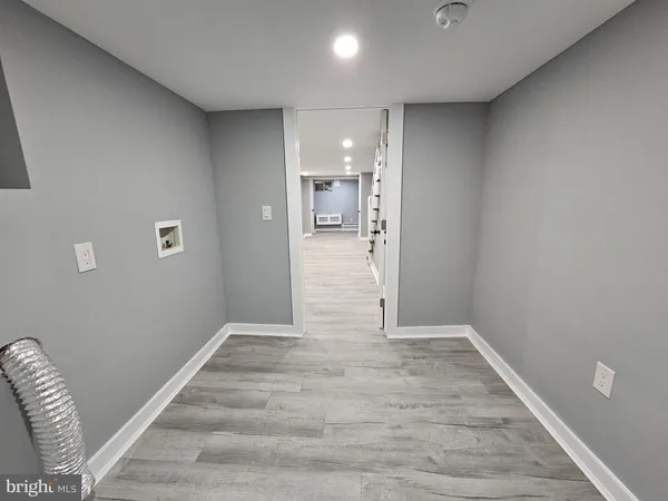 a view of hallway with a couch and a floor to ceiling window