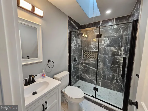 a bathroom with a sink toilet and shower