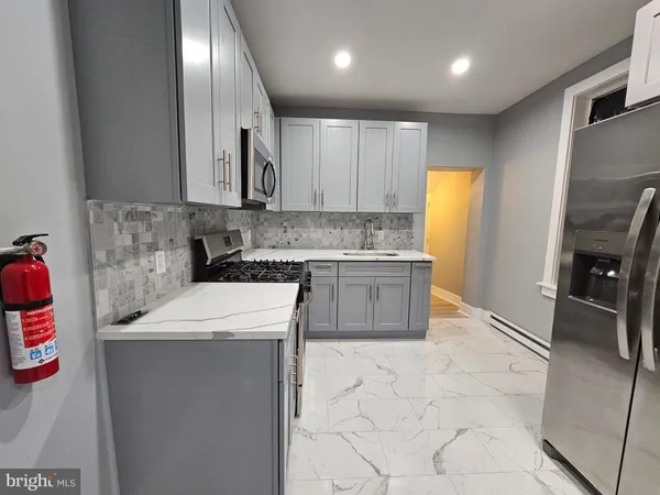 a kitchen with a sink appliances and cabinets