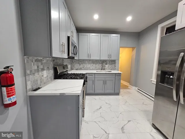 a kitchen with a sink appliances and cabinets