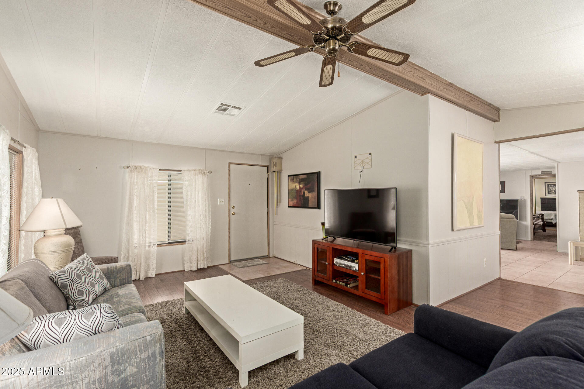 301 South Signal Butte Road, Unit 706 Apache Junction, AZ 85120 - Photo 10 of 48 a living room with furniture and a flat screen tv