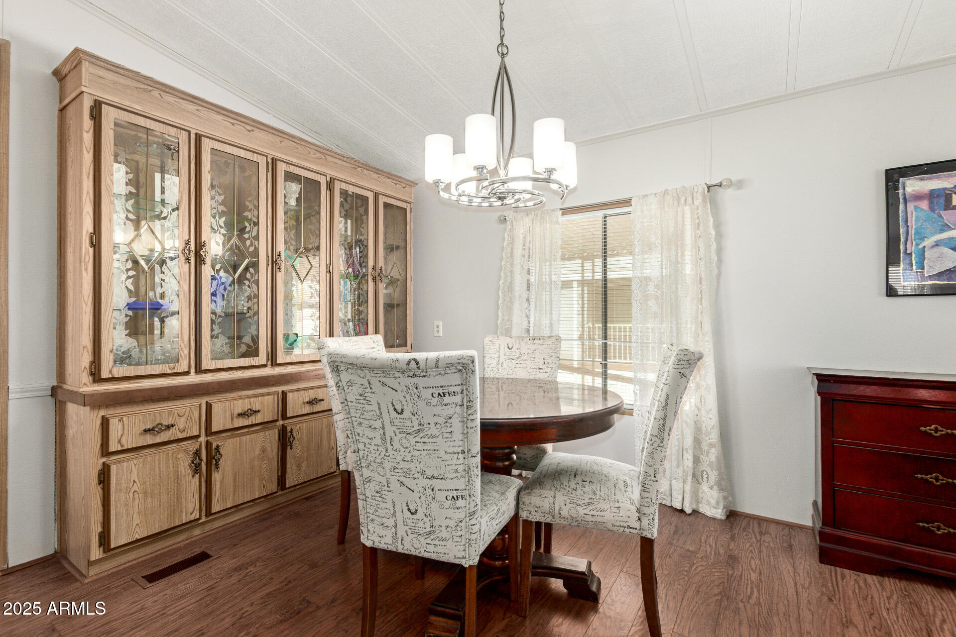 301 South Signal Butte Road, Unit 706 Apache Junction, AZ 85120 - Photo 12 of 48 a dining room with furniture a chandelier and wooden floor