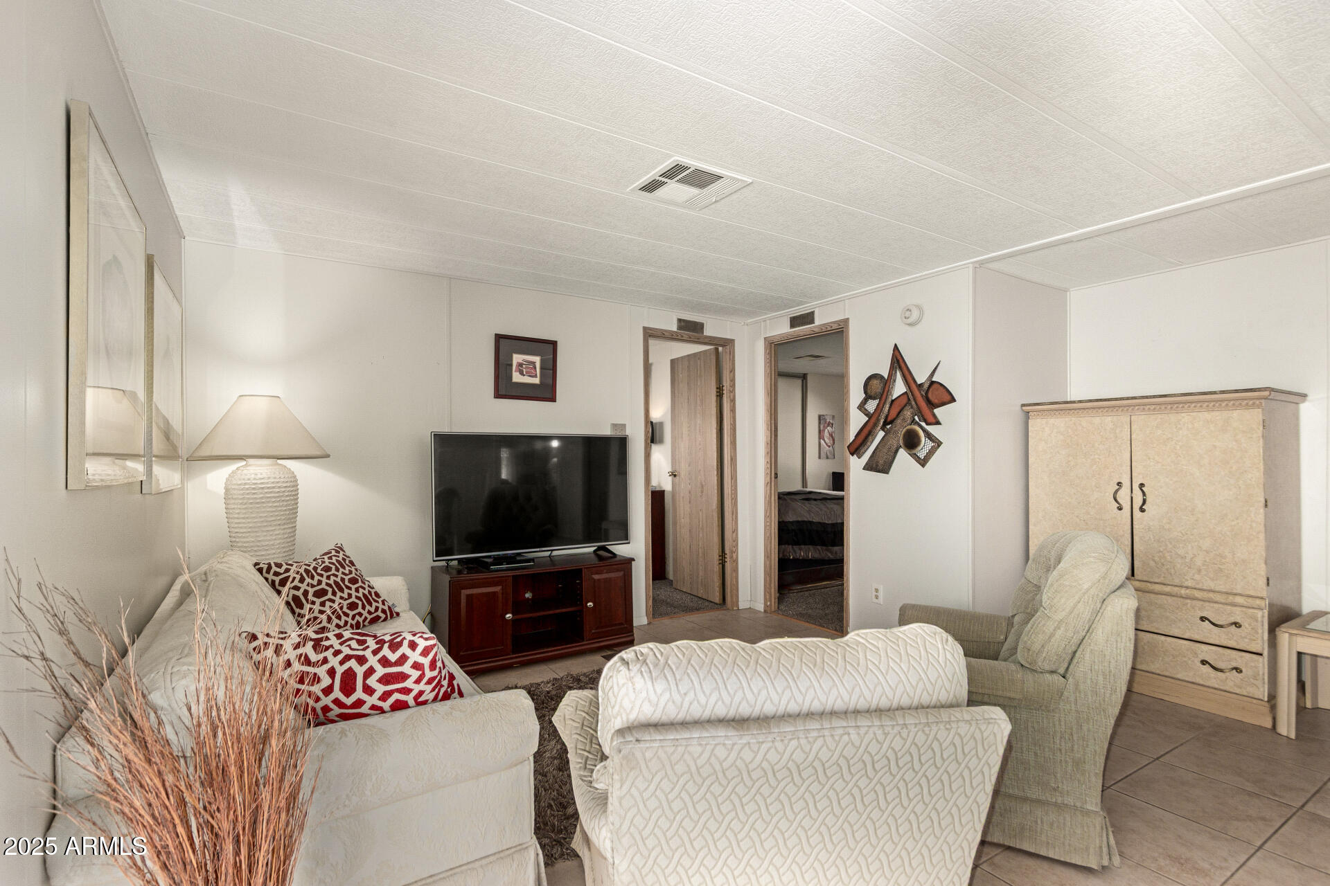 301 South Signal Butte Road, Unit 706 Apache Junction, AZ 85120 - Photo 16 of 48 a living room with furniture and a flat screen tv