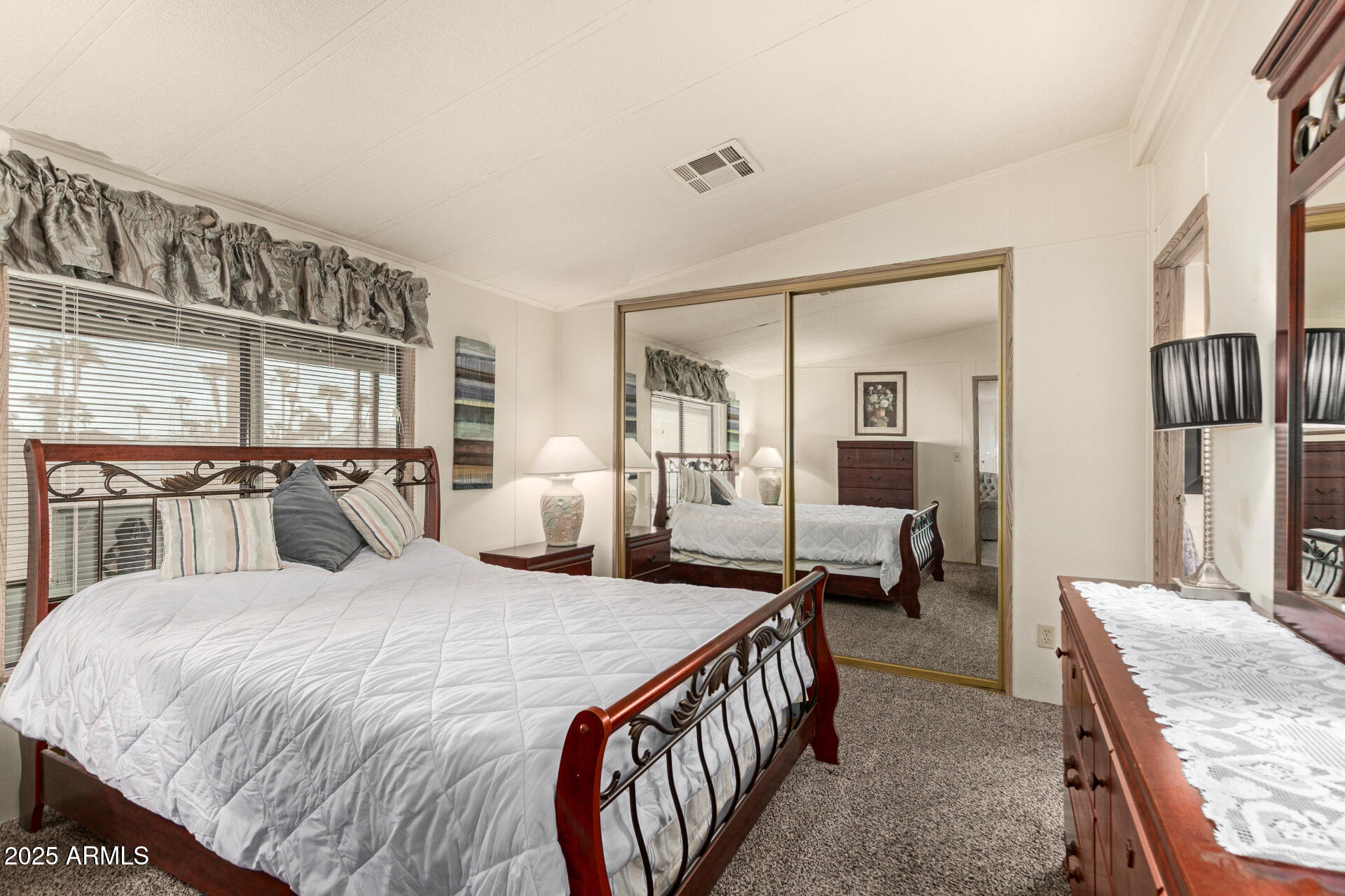 301 South Signal Butte Road, Unit 706 Apache Junction, AZ 85120 - Photo 20 of 48 a large bedroom with a bed a table and chair