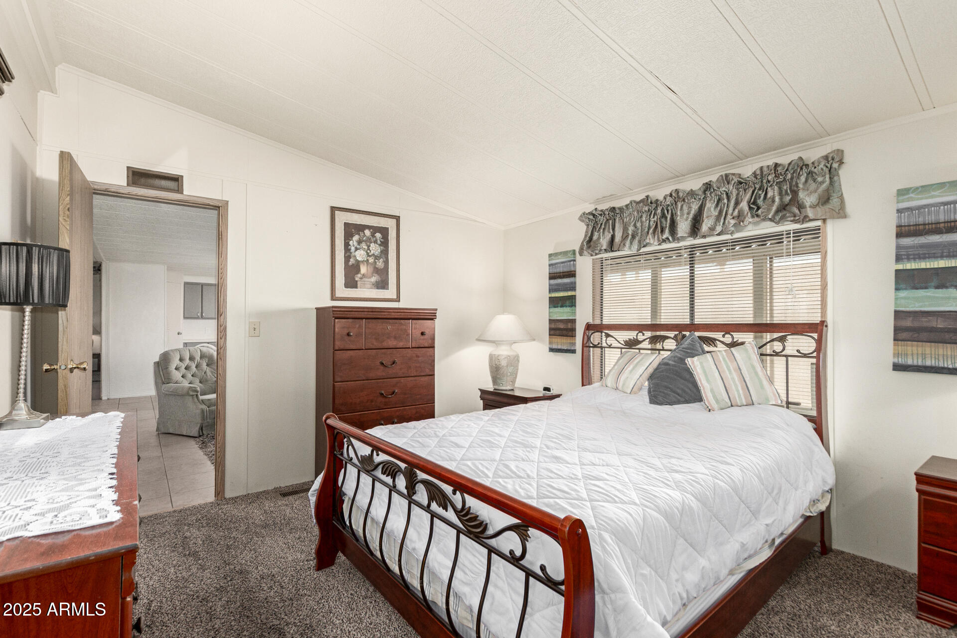 301 South Signal Butte Road, Unit 706 Apache Junction, AZ 85120 - Photo 22 of 48 a bedroom with a bed and a dresser with mirror