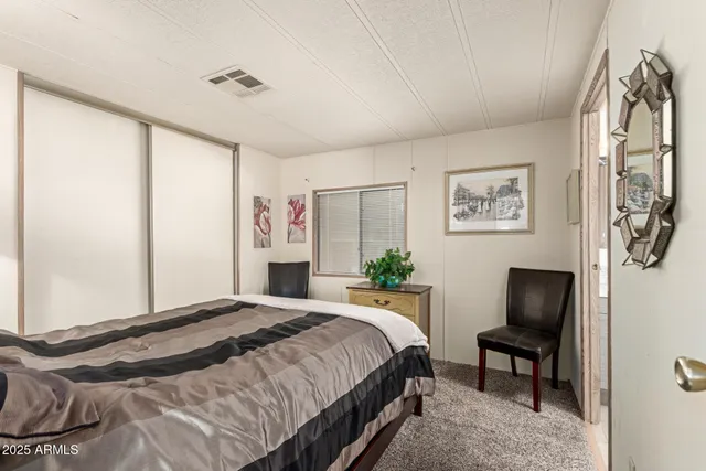 a bathroom with a sink a toilet a mirror and shower curtain