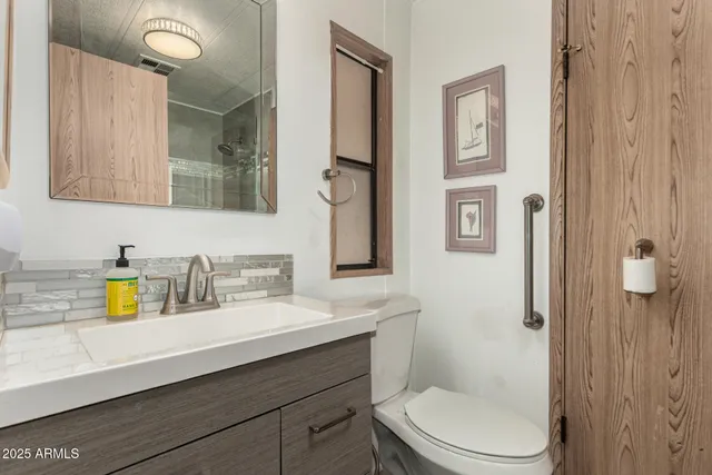 a bedroom with a bed and a mirror