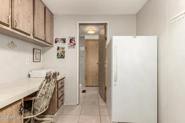 a view of kitchen with furniture and electronic appliances