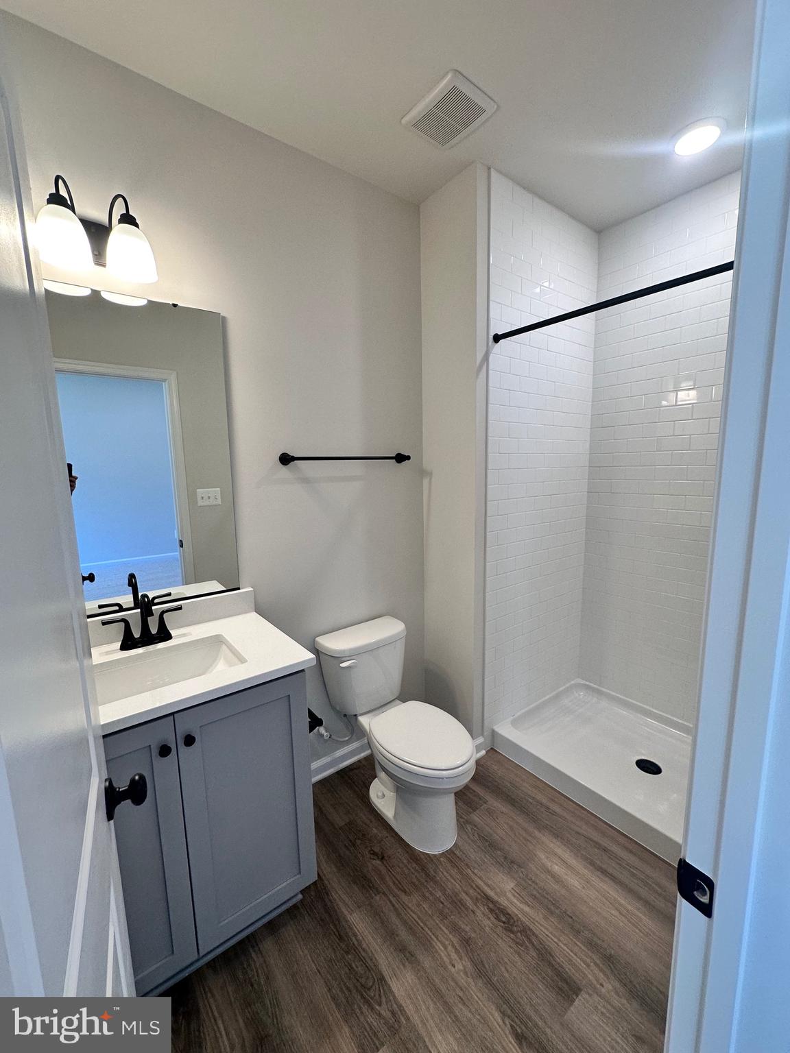 108 Spring Bank Way Frederick, MD 21701 - Photo 5 of 19 a bathroom with a sink toilet a mirror and shower
