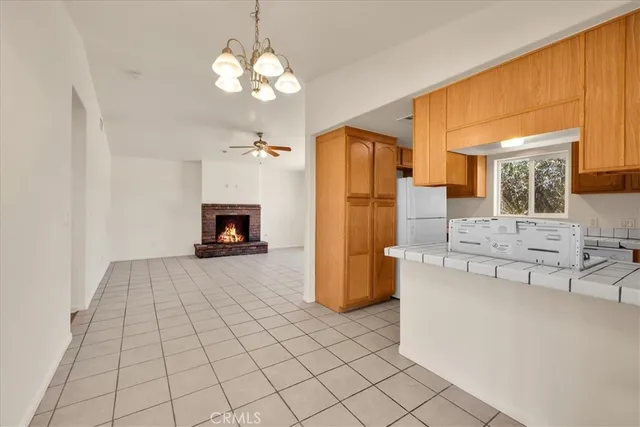 a bathroom with a granite countertop sink toilet and mirror