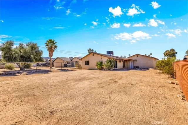 an aerial view of residential house and sandy dunes