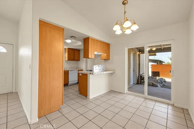 a room with a chandelier furniture and a large window
