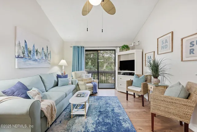a living room with furniture and kitchen view