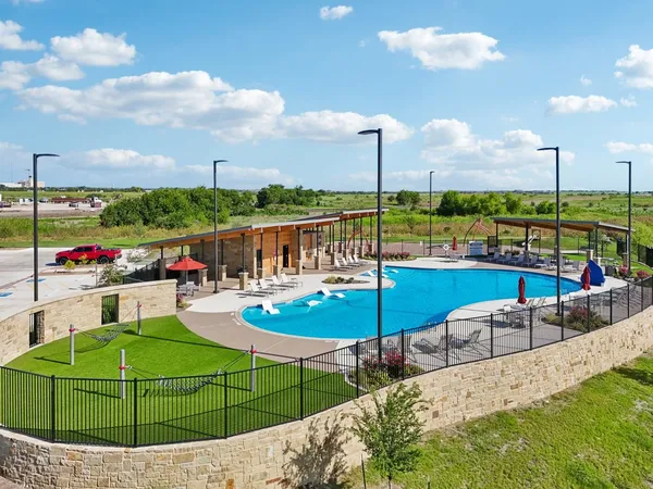 a view of a swimming pool with lawn chairs