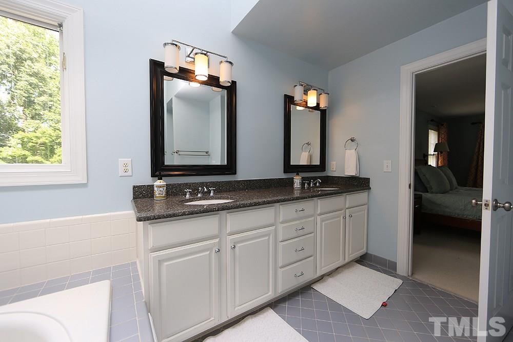 4008 Skipjack Court Raleigh, NC 27613 - Photo 11 of 21 a bathroom with 2 sink and a mirror