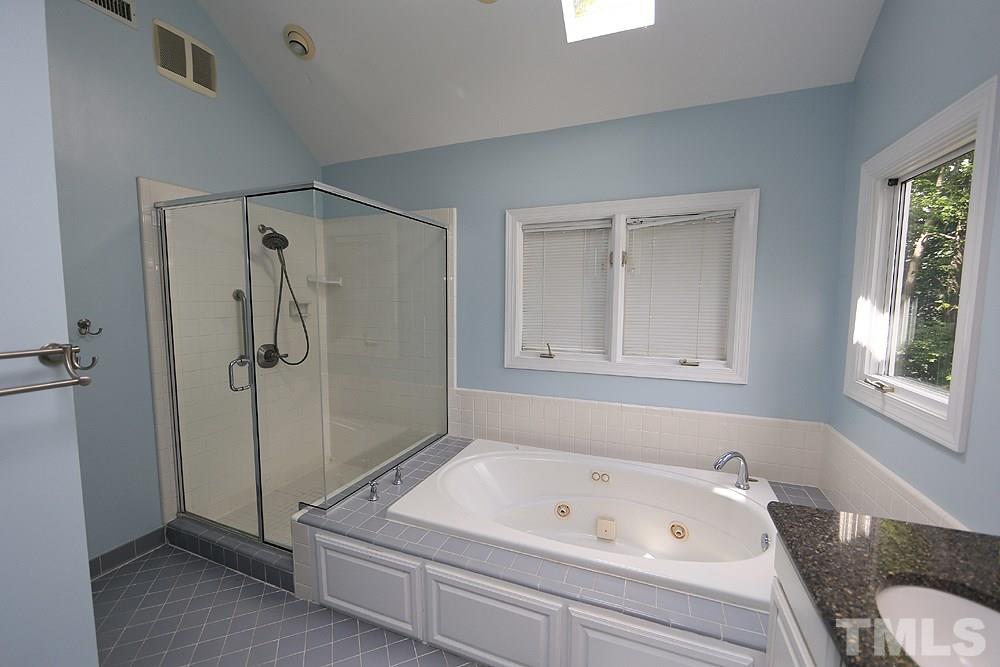 4008 Skipjack Court Raleigh, NC 27613 - Photo 12 of 21 a bathroom with a tub a window and a shower