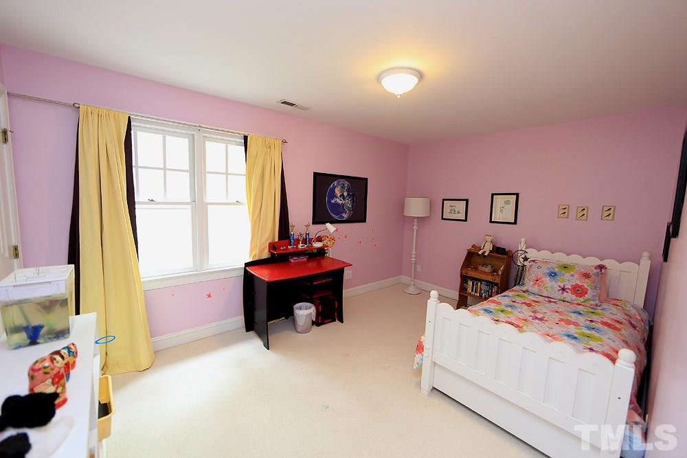 4008 Skipjack Court Raleigh, NC 27613 - Photo 13 of 21 a bed room with a bed and a chair