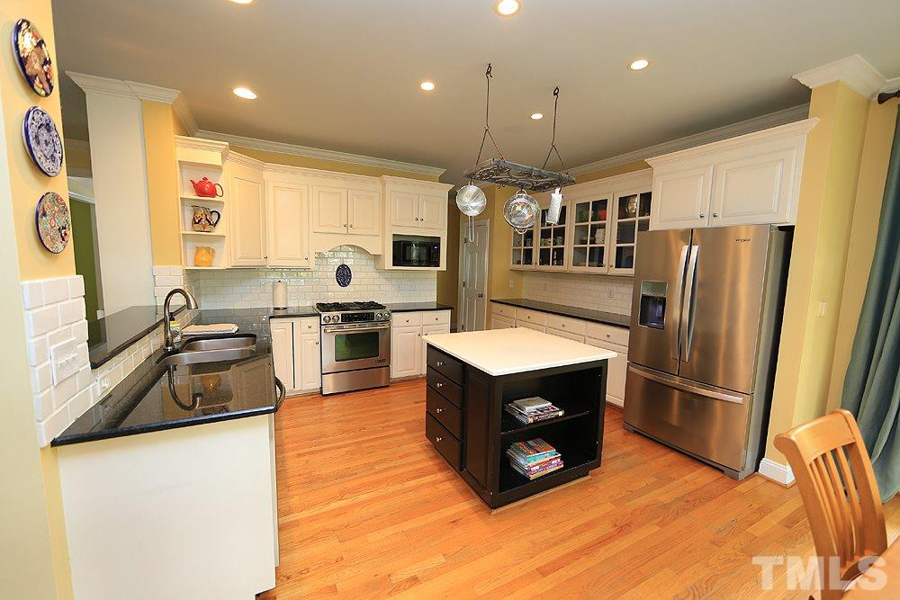 4008 Skipjack Court Raleigh, NC 27613 - Photo 9 of 21 a kitchen with stainless steel appliances granite countertop a refrigerator a oven a sink a stove and a refrigerator