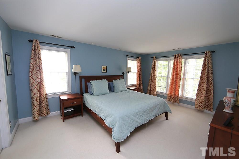 4008 Skipjack Court Raleigh, NC 27613 - Photo 10 of 21 a bedroom with a bed and a couch