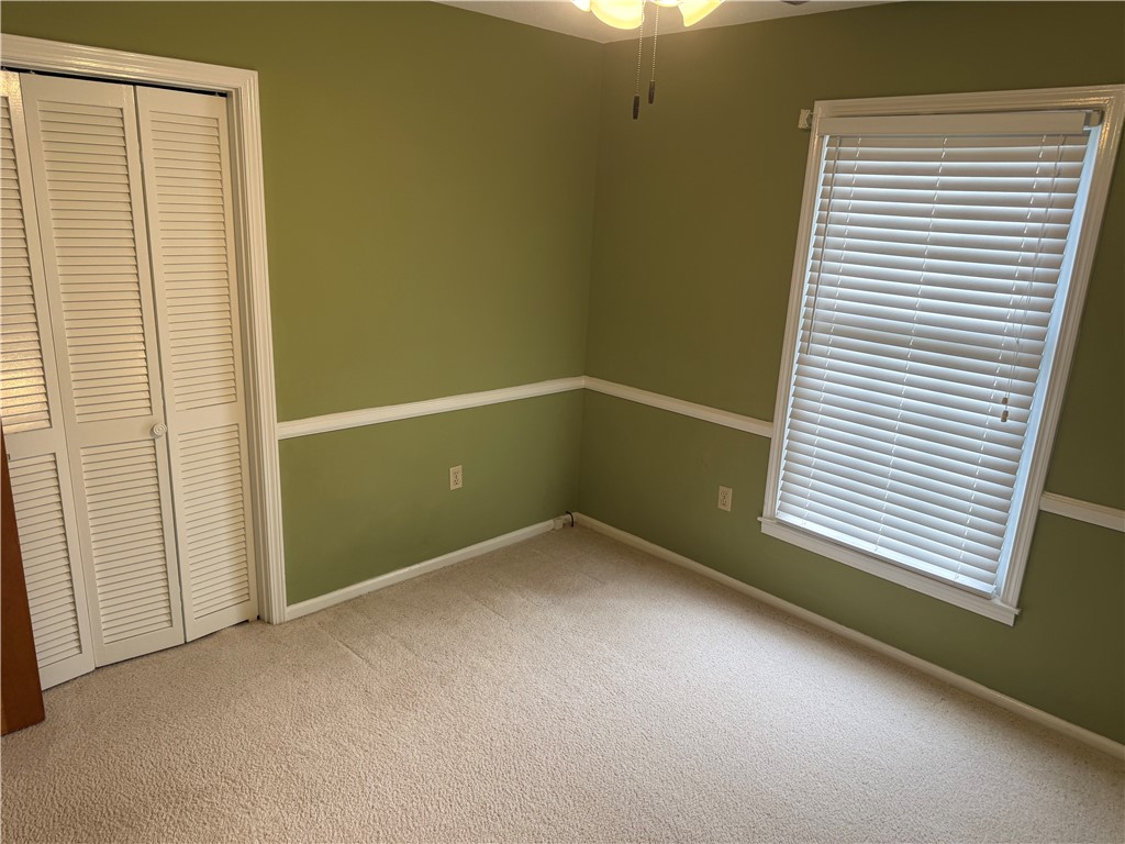 121 Nautical Way Anderson, SC 29625 - Photo 29 of 37 A well-maintained bedroom offers comfort and a tranquil atmosphere with its soft carpeting and a window for natural light.