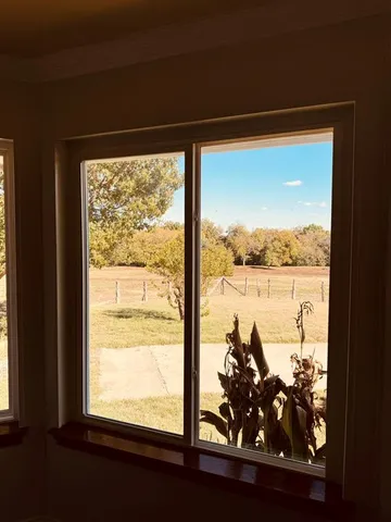 a kitchen with stainless steel appliances granite countertop a wooden floors and white cabinets