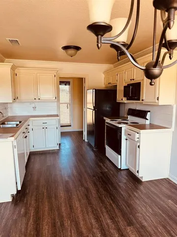 a kitchen with a refrigerator stove and microwave