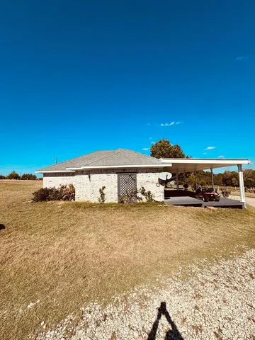a view of a water fountain and a big yard