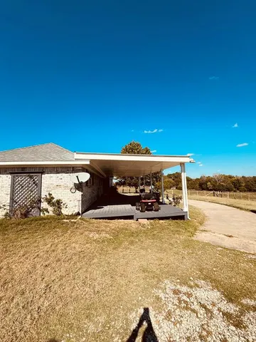 a view of a house with a yard outdoor space and sitting area