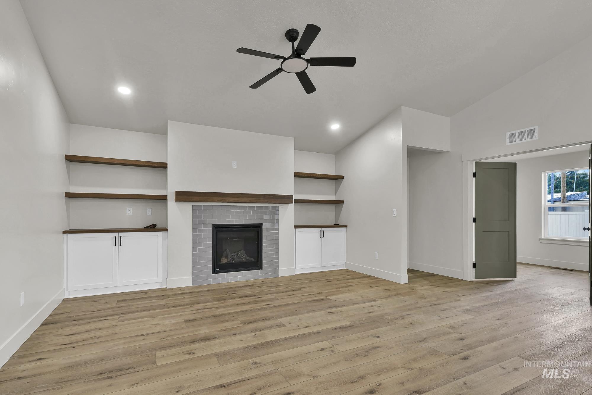 1130 Velvet Loop Wilder, ID 83676 - Photo 5 of 35 Spacious room featuring wood-finish flooring, a contemporary ceiling fan, and recessed lighting