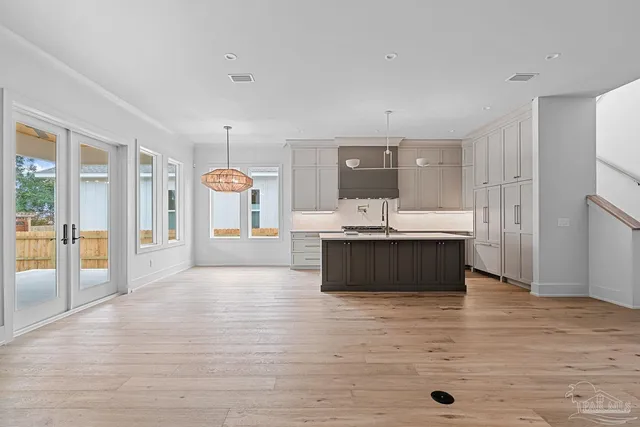 a view of empty room with wooden floor and fireplace